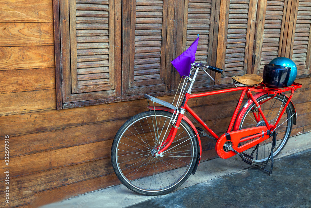 Red bike and wooden cover.