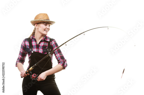 Happy woman in sun hat holding fishing rod photo