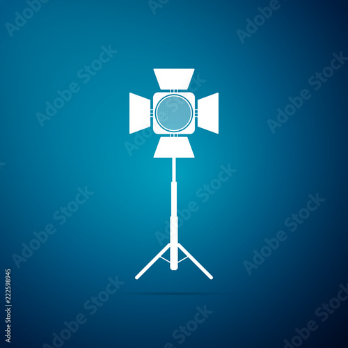 Movie spotlight icon isolated on blue background. Light Effect. Scene, Studio, Show. Flat design. Vector Illustration