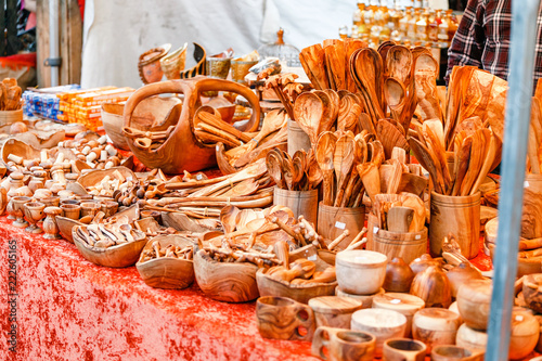 Handmade wooden spoons and vintage kitchen utensils for sale at the market