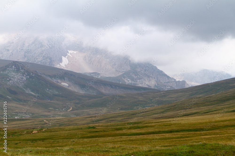 Fototapeta premium natural landscape photo of northern mountain landscape with heavy grey cloudy sky