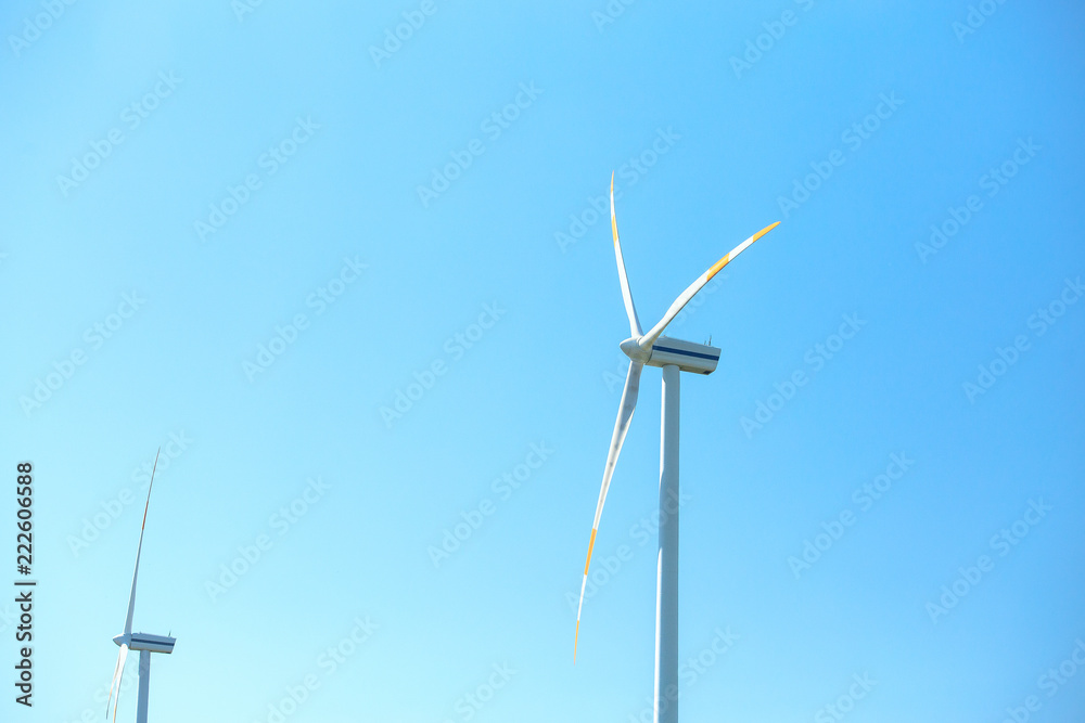Electric wind mill turbines with blue sky background Electric wind mill turbines with blue sky background