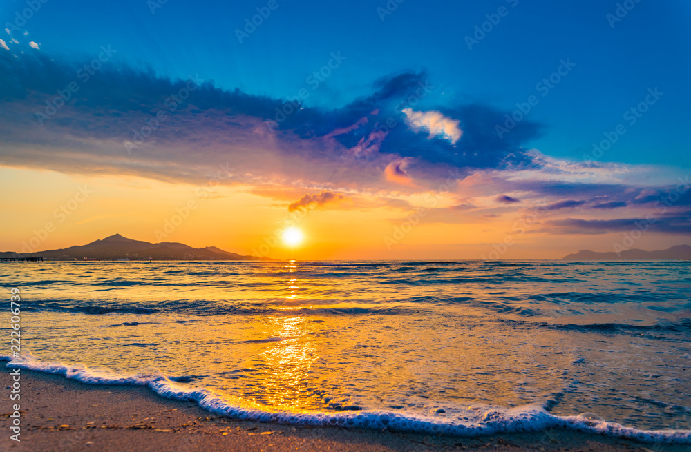 Idyllic evening twilight on the beach with soft sea water wave