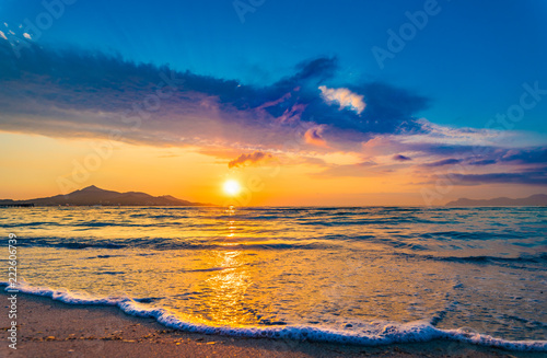 Idyllic evening twilight on the beach with soft sea water wave