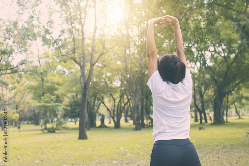 sport woman worm up in park in morning, work out and exercise concept