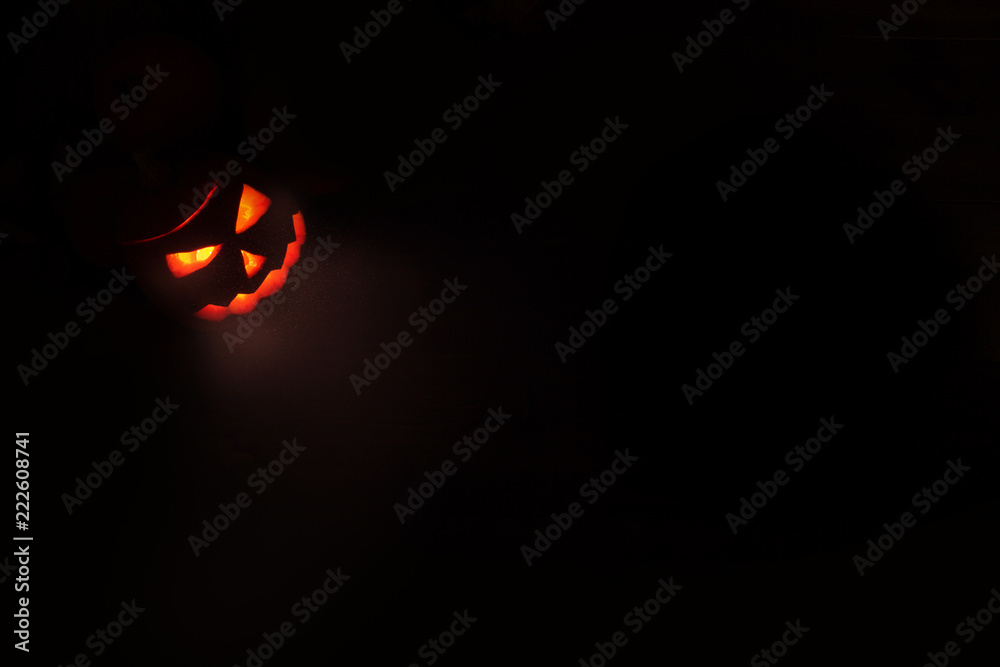 Halloween concept, glowing red outline of Jack's lantern from the carved pumpkin from which the light comes. isolate on black background Halloween concept, glowing red outline of Jack's lantern from the carved pumpkin from which the light comes. isolate on black background