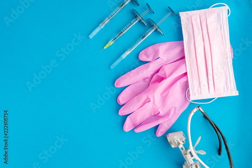 Medical equipments including surgical instruments on a blue background. top view, copy spase