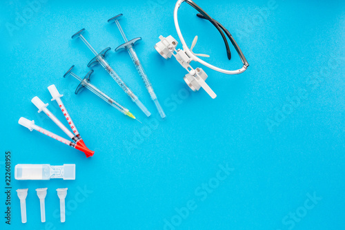 Medical equipments including surgical instruments on a blue background. top view  copy spase