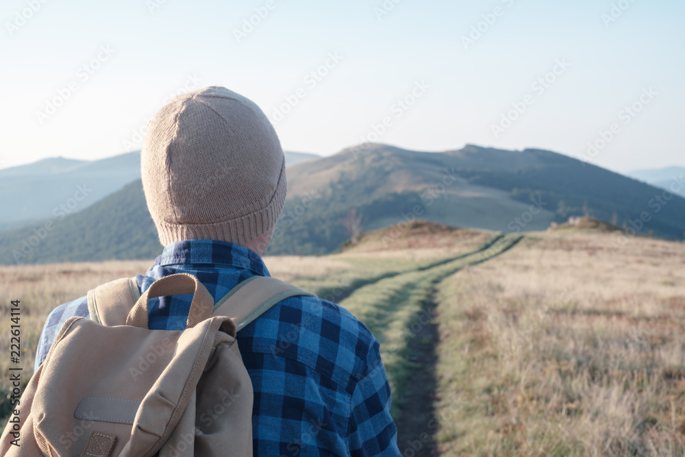 Man with backpack on mountains road. Travel concept. Landscape photography Man with backpack on mountains road. Travel concept. Landscape photography