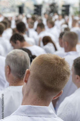 Meeting of people in white clothes. Vertical photo
