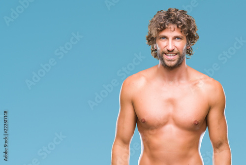 Handsome hispanic model man sexy and shirtless over isolated background with a happy and cool smile on face. Lucky person.