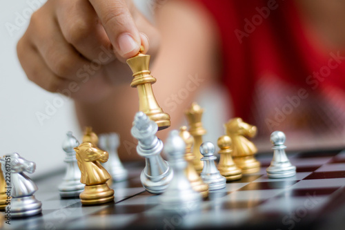 Hand of woman playing chess