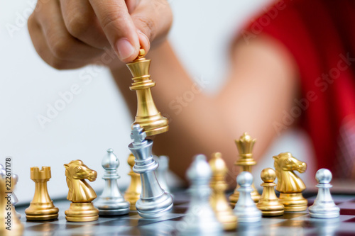 Hand of woman playing chess for business tactic and planning metaphor select focus shallow depth of field