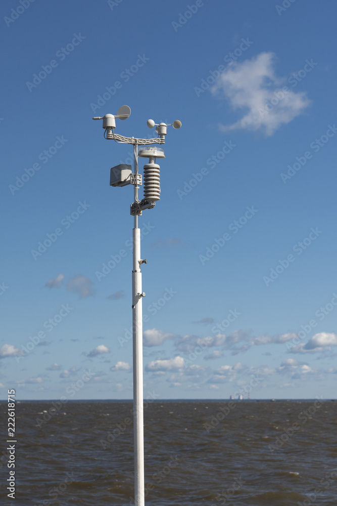  Weather station amid the stormy sea, with blue skies and clouds.