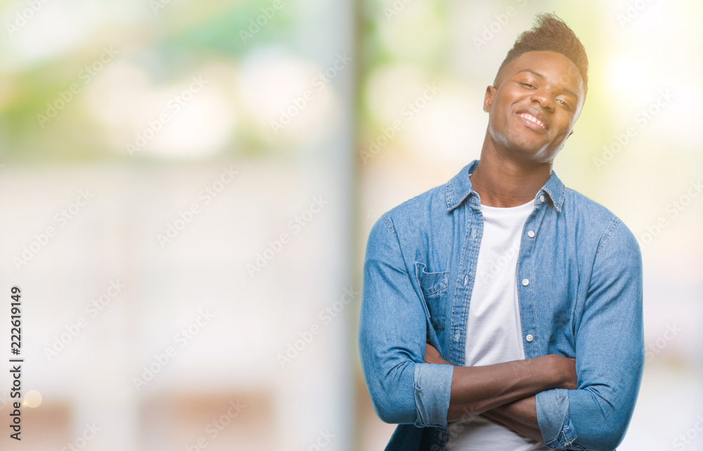 Fototapeta premium Young african american man over isolated background happy face smiling with crossed arms looking at the camera. Positive person.