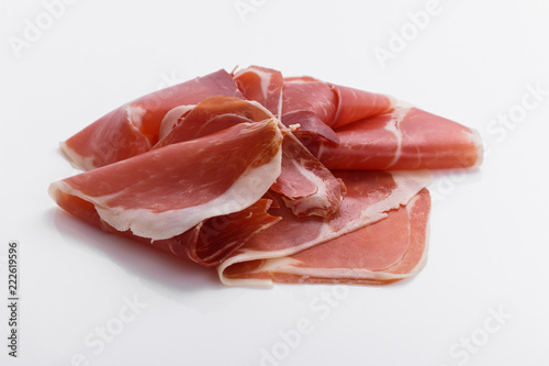 Italian prosciutto crudo or spanish jamon on a white background