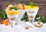 Healthy breakfast. Oat granola with yoghurt, apricot on a light wooden background