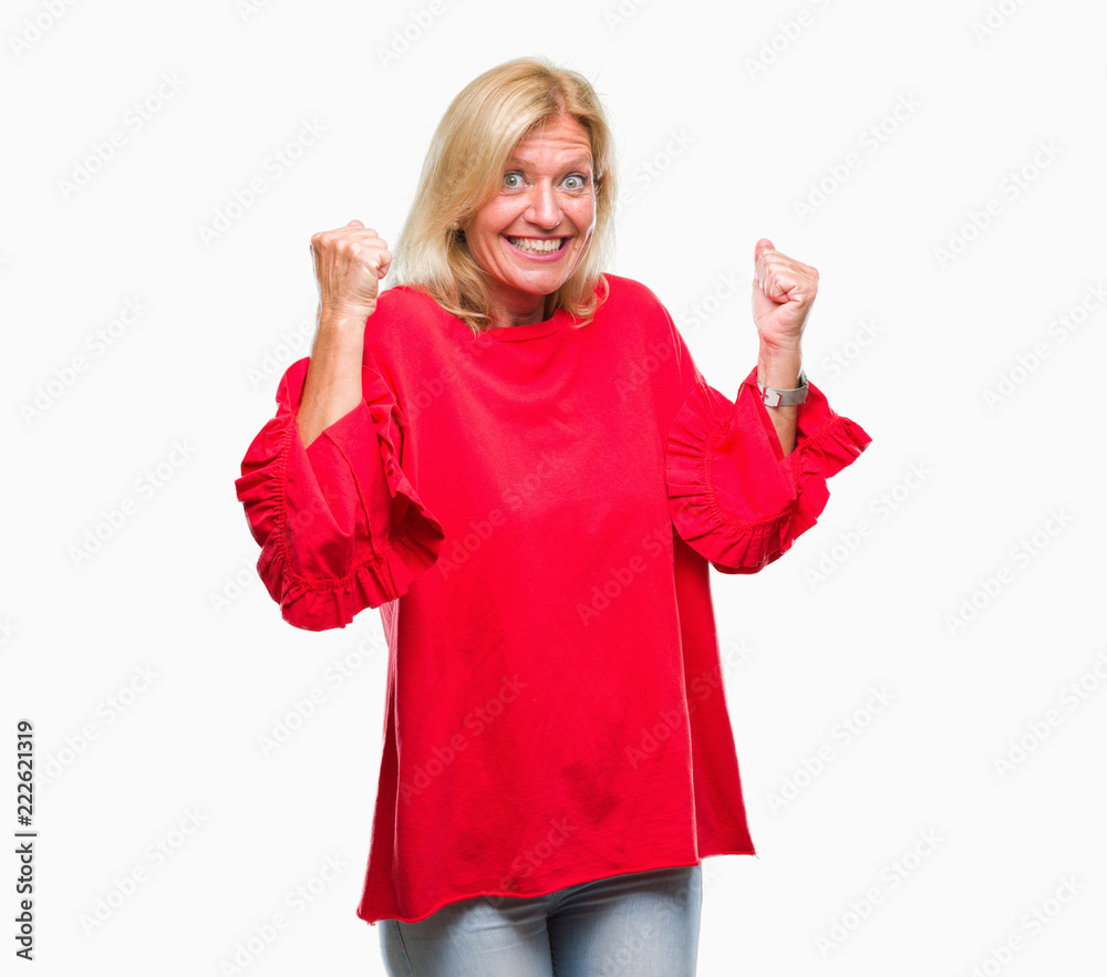 Middle age blonde woman over isolated background very happy and excited doing winner gesture with arms raised, smiling and screaming for success. Celebration concept. Middle age blonde woman over isolated background very happy and excited doing winner gesture with arms raised, smiling and screaming for success. Celebration concept.