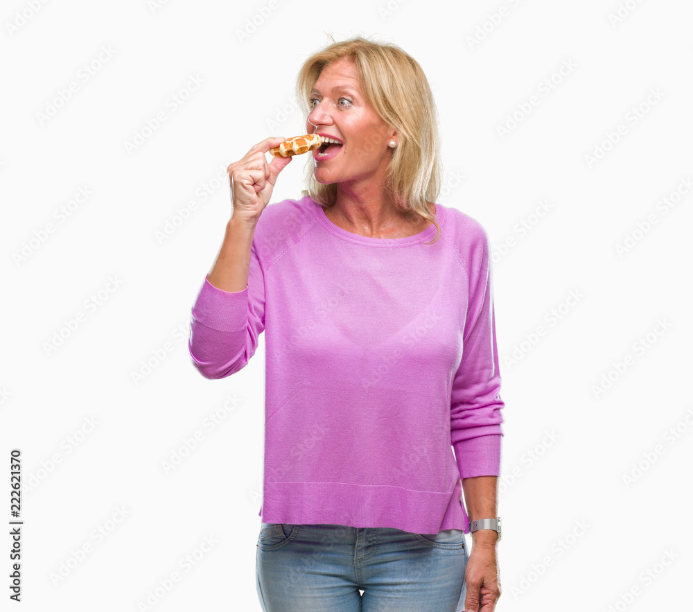 Middle age blonde woman eating sweet waffle over isolated background with a confident expression on smart face thinking serious Middle age blonde woman eating sweet waffle over isolated background with a confident expression on smart face thinking serious