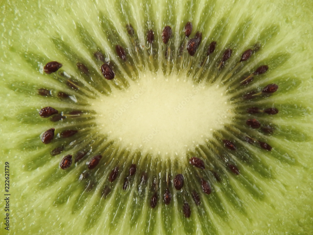 Top view and close up texture of ripe fresh kiwifruits. With radial shape, bright green flesh and edible black seeds.Sweet and unique taste.Natural, healthy and nutritious food.With copy space. Top view and close up texture of ripe fresh kiwifruits. With radial shape, bright green flesh and edible black seeds.Sweet and unique taste.Natural, healthy and nutritious food.With copy space.