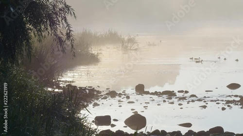 View on the foggy river at the early morning