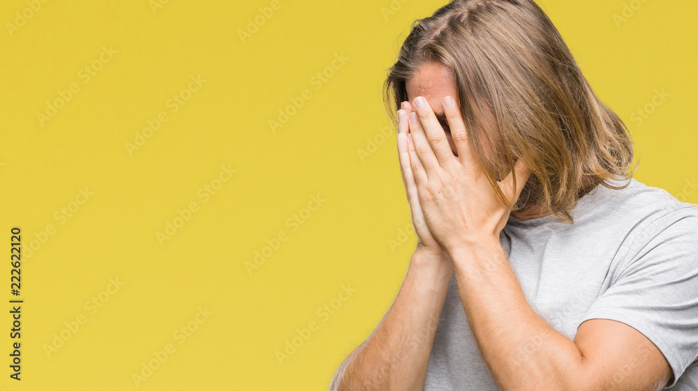 Young handsome man with long hair over isolated background with sad expression covering face with hands while crying. Depression concept. Young handsome man with long hair over isolated background with sad expression covering face with hands while crying. Depression concept.