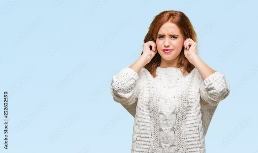 Young beautiful woman over isolated background wearing winter sweater covering ears with fingers with annoyed expression for the noise of loud music. Deaf concept. Young beautiful woman over isolated background wearing winter sweater covering ears with fingers with annoyed expression for the noise of loud music. Deaf concept.
