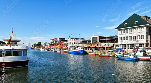 Fotografie Small fishing boats lie in the fishing port alter strom in the Baltic Sea resort Warnemünde