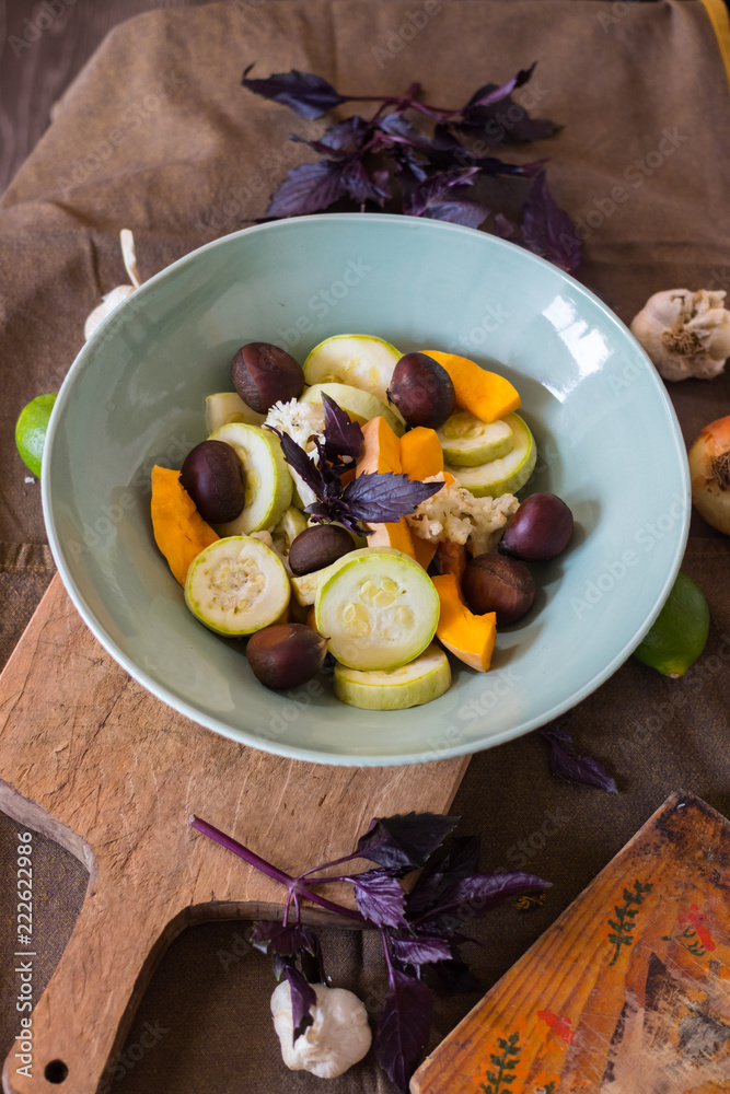 Steamed cooked vegetables stew (zucchini, pumpkin, cauliflower) in a big ceramic bowl with fried chestnuts. Dieting vegan lunch, non-gluten nuts, vegetarian dinner, healthy food concept Steamed cooked vegetables stew (zucchini, pumpkin, cauliflower) in a big ceramic bowl with fried chestnuts. Dieting vegan lunch, non-gluten nuts, vegetarian dinner, healthy food concept