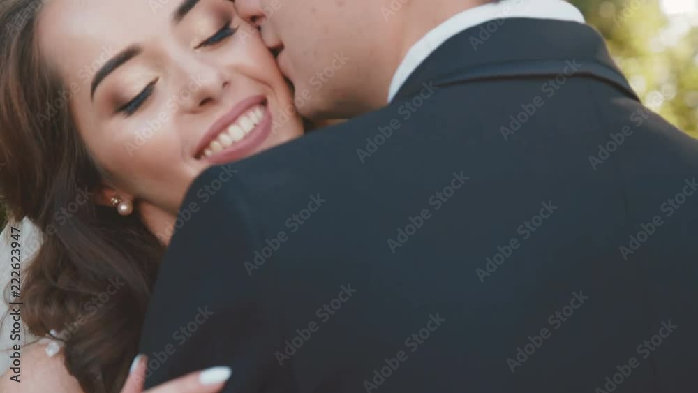 Beautiful wedding couple in embrace, looks and caresses each other Beautiful wedding couple in embrace, looks and caresses each other