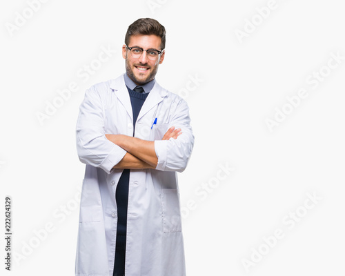 Young handsome man wearing doctor, scientis coat over isolated background happy face smiling with crossed arms looking at the camera. Positive person. photo