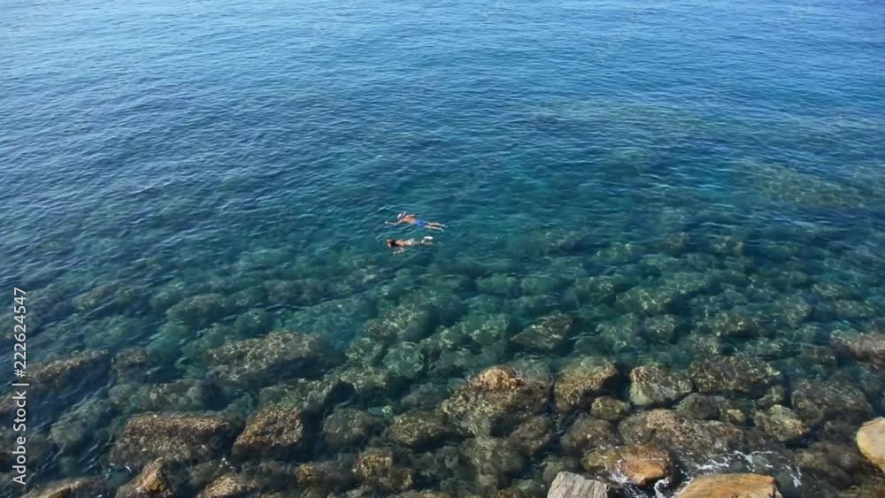 People snorkeling in beautiful blue sea People snorkeling in beautiful blue sea