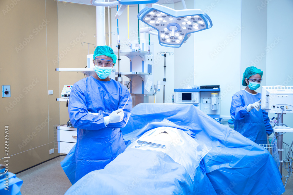 Portrait of male surgeon , operation in the background. Portrait of male surgeon , operation in the background.