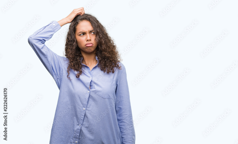 Young hispanic business woman confuse and wonder about question. Uncertain with doubt, thinking with hand on head. Pensive concept. Young hispanic business woman confuse and wonder about question. Uncertain with doubt, thinking with hand on head. Pensive concept.