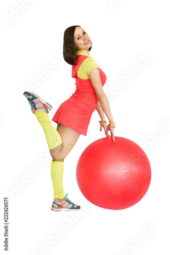 Young beautiful girl doing fitness exercises with ball, isolated on a white background.