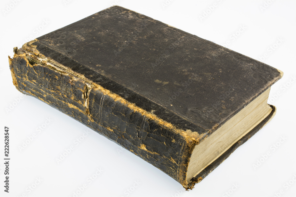 A Large ancient shabby book of brown color is isolated on a white background. A Large ancient shabby book of brown color is isolated on a white background.