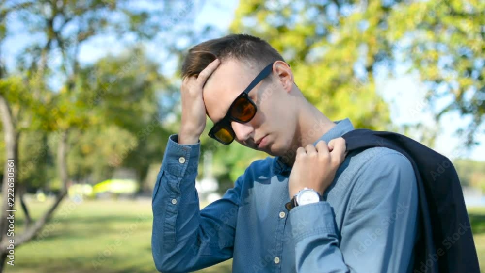 Portrait of young businessman in a shirt and sunglasses looking cool, sexy, smart and stylish on camera Portrait of young businessman in a shirt and sunglasses looking cool, sexy, smart and stylish on camera