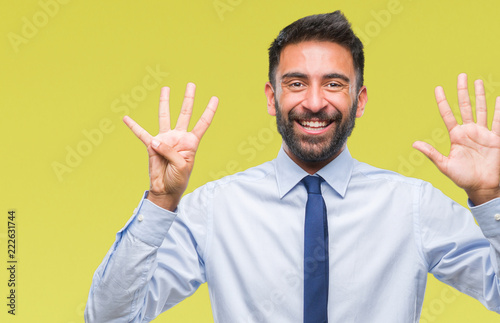 Adult hispanic business man over isolated background showing and pointing up with fingers number nine while smiling confident and happy.