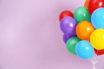Bunch of bright balloons and space for text against color background