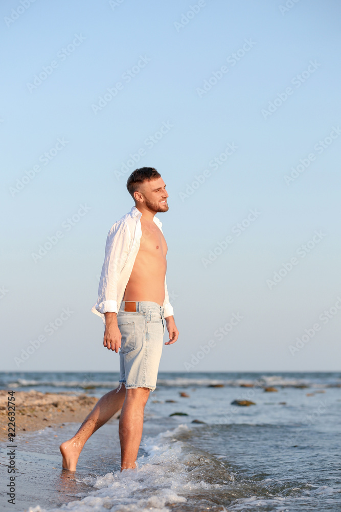 Young man enjoying sunny day on beach