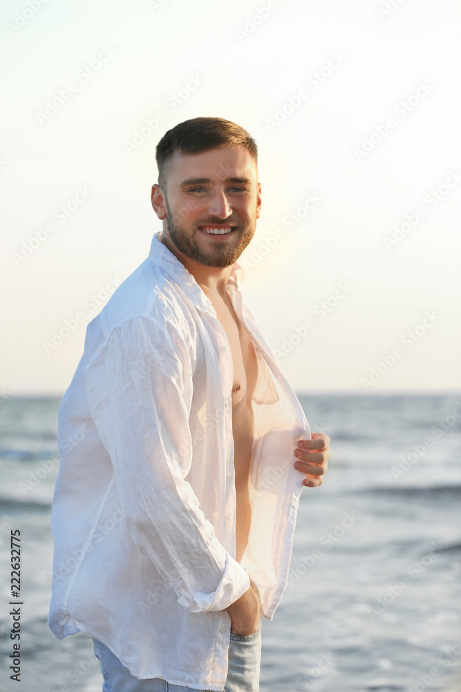 Young man enjoying sunny day on beach