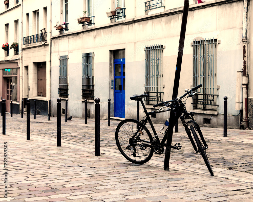 Paris street - pavement roadway and bike parked. Typical french. Paris street - pavement roadway and bike parked. Typical french.