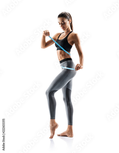 Young slim girl in sportswear isolated on white background. Concept of healthy life and natural balance between body and mental development. Full length