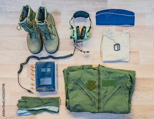 Military flying airman uniform with headset flat lay background