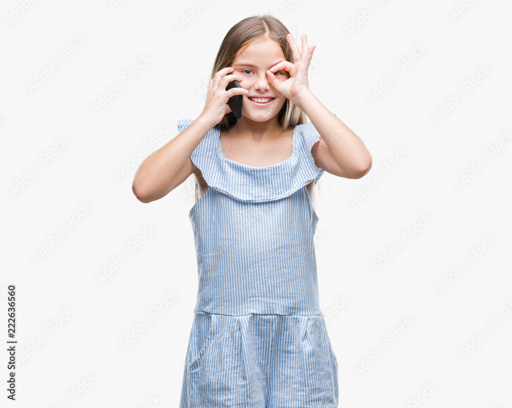 Young beautiful girl talking on the phone over isolated background with happy face smiling doing ok sign with hand on eye looking through fingers Young beautiful girl talking on the phone over isolated background with happy face smiling doing ok sign with hand on eye looking through fingers