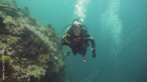 Wallpaper Mural Diver in equipment with regulator in mouth under the water blows air bubbles. Face diver in mask close-up. Torontodigital.ca