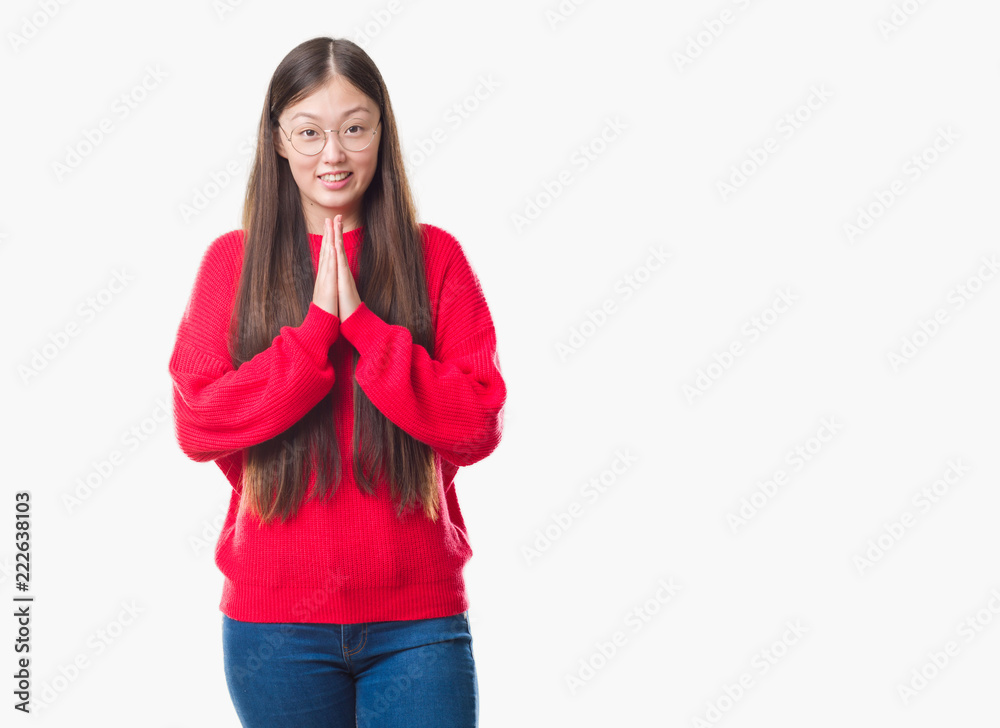 Young Chinese woman over isolated background wearing glasses praying with hands together asking for forgiveness smiling confident. Young Chinese woman over isolated background wearing glasses praying with hands together asking for forgiveness smiling confident.