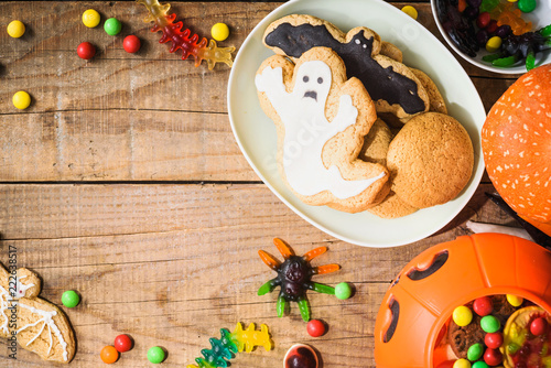 Fototapeta Naklejka Na Ścianę i Meble -  Halloween candies on wood table - holiday background