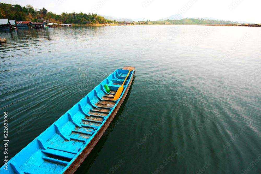 Blue tradition wooden boat on the river in Sangklaburi at Kanchanaburi Province, Thailand