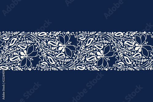 Indigo dye woodblock printed seamless ethnic floral border. Traditional oriental ornament of India, garland of flowers and leaves, ecru on  navy blue background. Textile design.